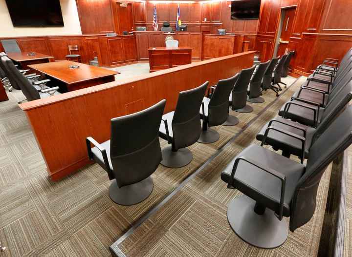 Image of an empty jury box in a courtroom