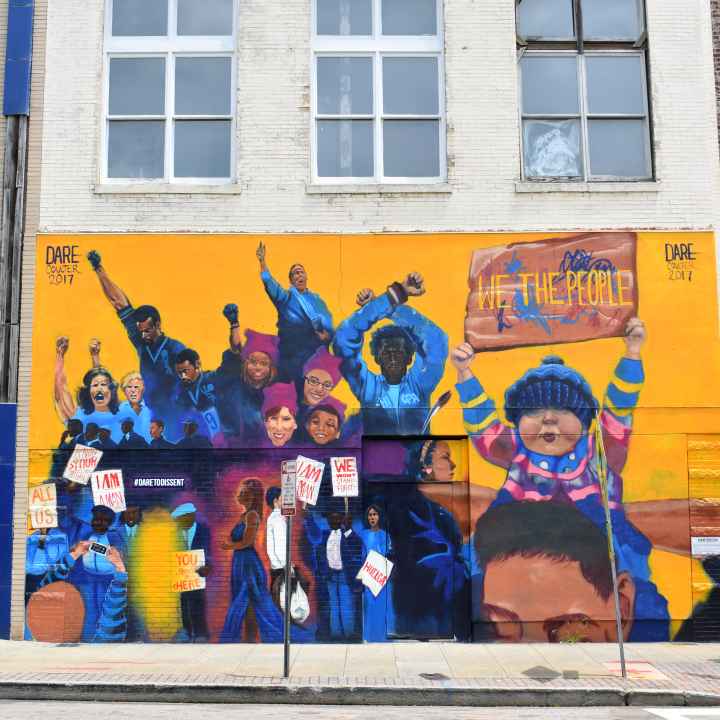 Dare To Dissent mural in downtown Raleigh featuring iconic protests